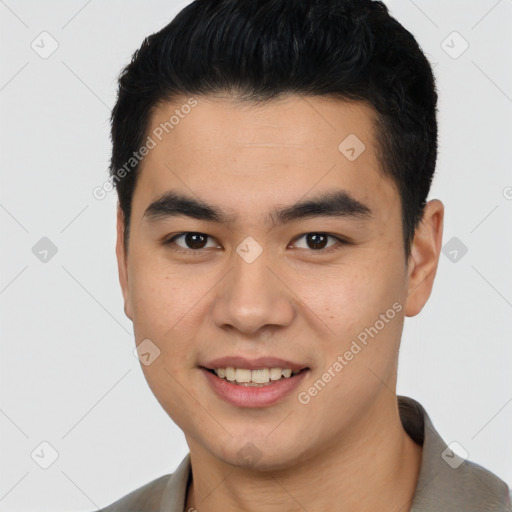 Joyful asian young-adult male with short  brown hair and brown eyes