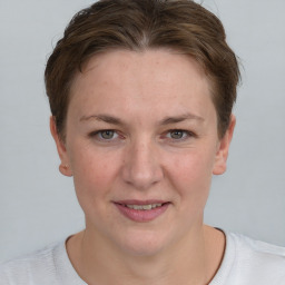 Joyful white young-adult female with short  brown hair and grey eyes