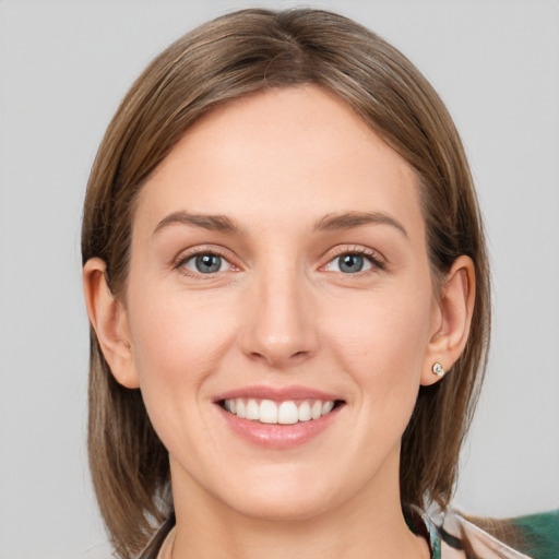 Joyful white young-adult female with medium  brown hair and grey eyes