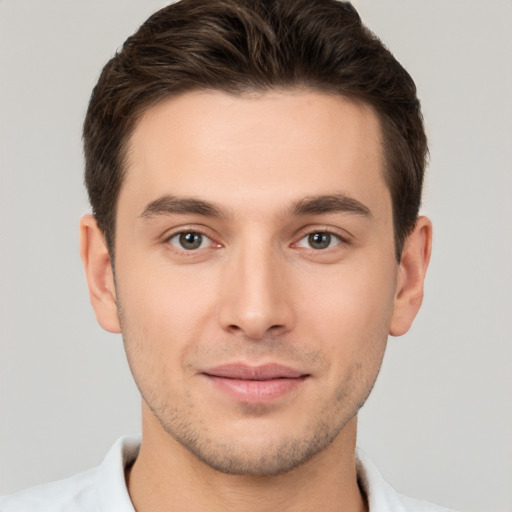 Joyful white young-adult male with short  brown hair and brown eyes