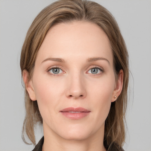 Joyful white young-adult female with medium  brown hair and grey eyes