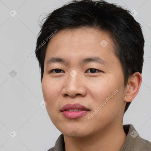 Joyful asian young-adult male with short  brown hair and brown eyes