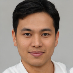 Joyful asian young-adult male with short  brown hair and brown eyes