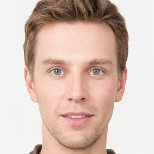 Joyful white young-adult male with short  brown hair and grey eyes