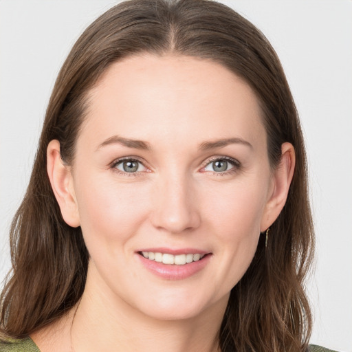 Joyful white young-adult female with long  brown hair and grey eyes