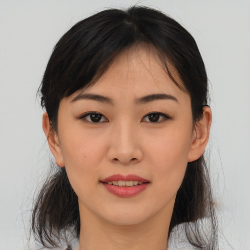 Joyful asian young-adult female with medium  brown hair and brown eyes