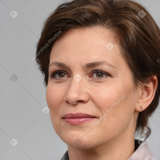 Joyful white adult female with medium  brown hair and brown eyes