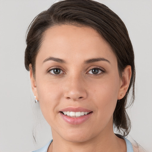 Joyful white young-adult female with medium  brown hair and brown eyes