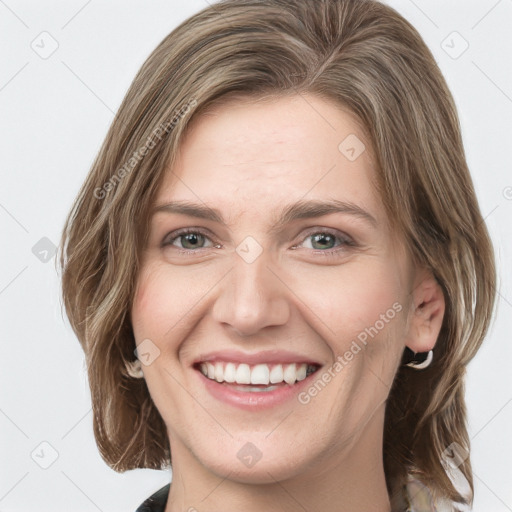 Joyful white young-adult female with medium  brown hair and green eyes