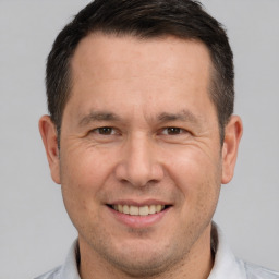 Joyful white adult male with short  brown hair and brown eyes