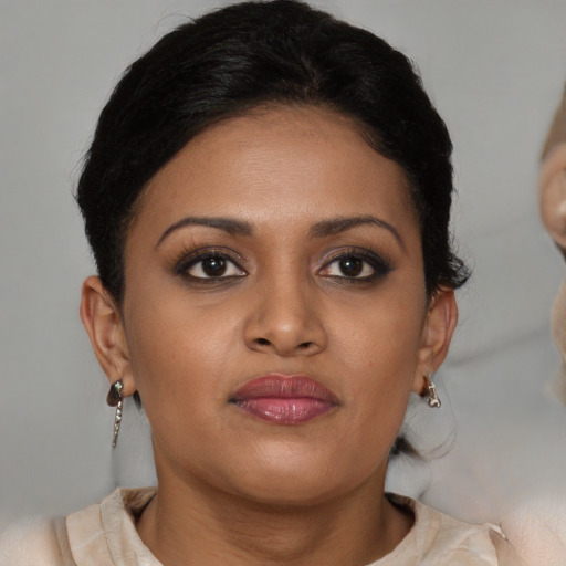 Joyful black young-adult female with medium  brown hair and brown eyes