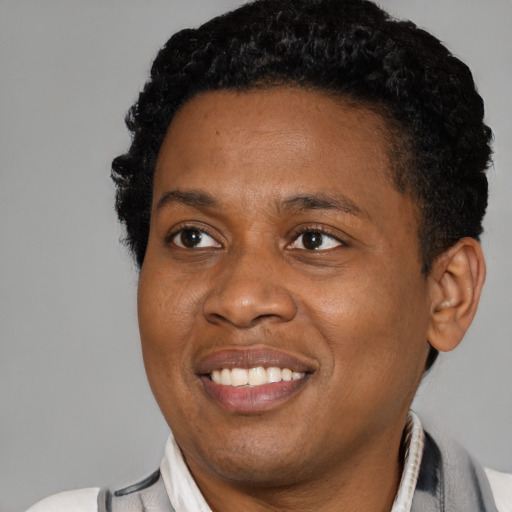 Joyful black young-adult male with short  black hair and brown eyes