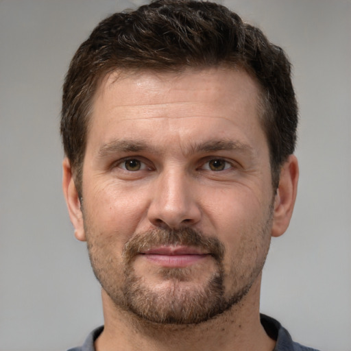 Joyful white adult male with short  brown hair and brown eyes