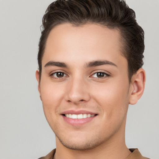 Joyful white young-adult male with short  brown hair and brown eyes