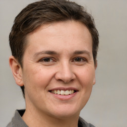 Joyful white adult female with short  brown hair and grey eyes