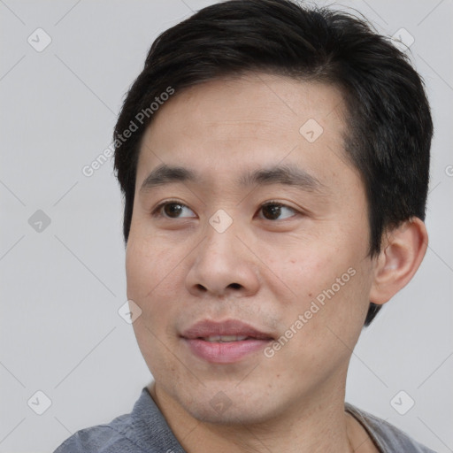 Joyful asian young-adult male with short  brown hair and brown eyes