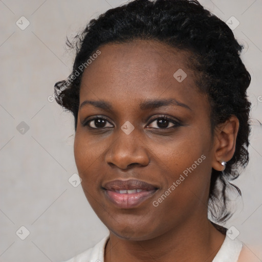 Joyful black young-adult female with medium  black hair and brown eyes