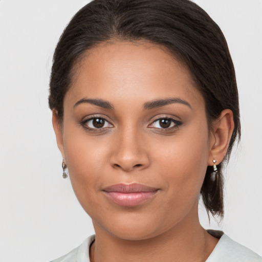 Joyful latino young-adult female with medium  brown hair and brown eyes