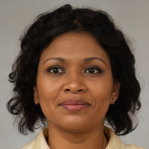 Joyful black young-adult female with medium  brown hair and brown eyes