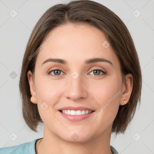 Joyful white young-adult female with medium  brown hair and grey eyes