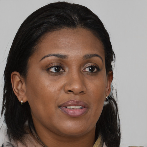 Joyful black young-adult female with medium  brown hair and brown eyes