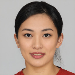 Joyful asian young-adult female with short  black hair and brown eyes