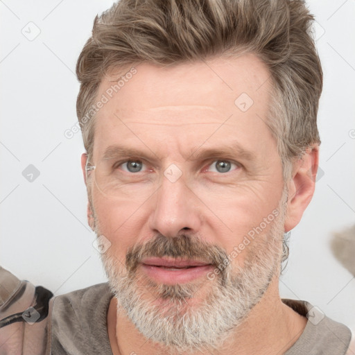 Joyful white adult male with short  brown hair and grey eyes