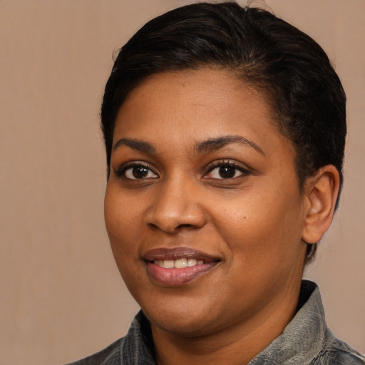 Joyful black young-adult female with medium  brown hair and brown eyes