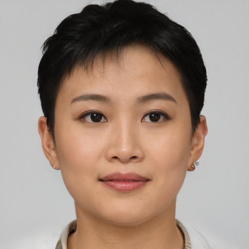 Joyful asian young-adult female with short  black hair and brown eyes