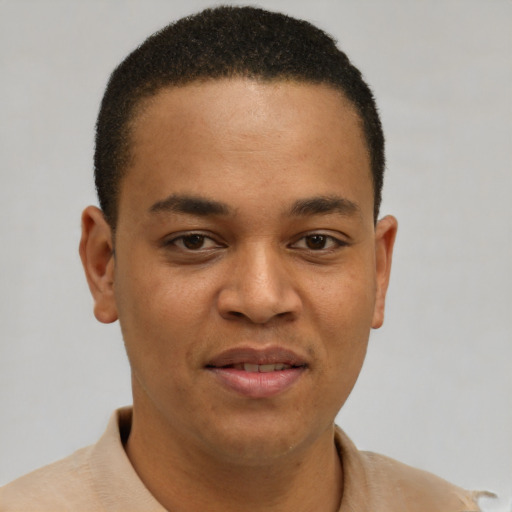 Joyful latino young-adult male with short  brown hair and brown eyes