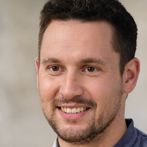 Joyful white adult male with short  brown hair and brown eyes