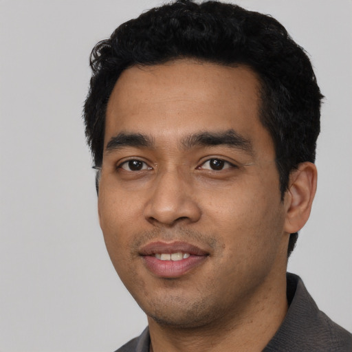 Joyful asian young-adult male with short  black hair and brown eyes