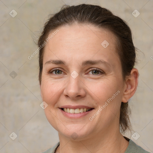 Joyful white adult female with short  brown hair and grey eyes