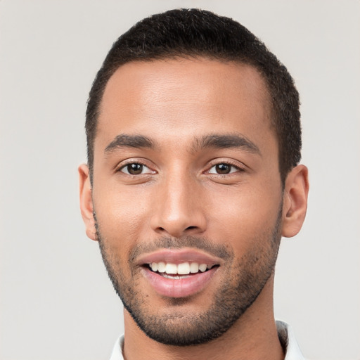 Joyful white young-adult male with short  black hair and brown eyes