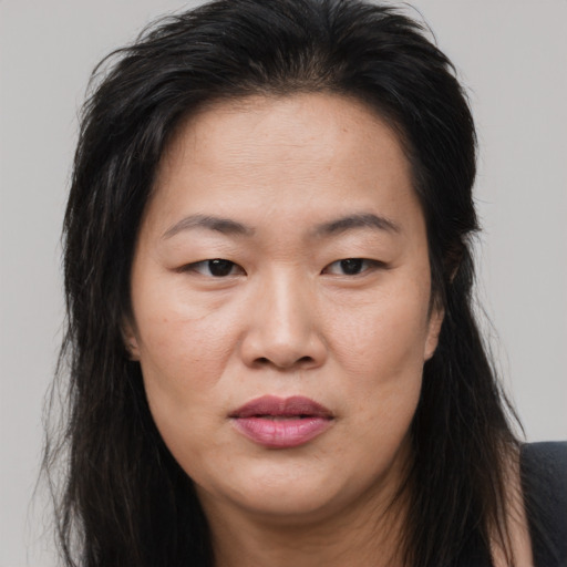 Joyful asian young-adult female with long  brown hair and brown eyes