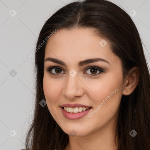 Joyful white young-adult female with long  brown hair and brown eyes