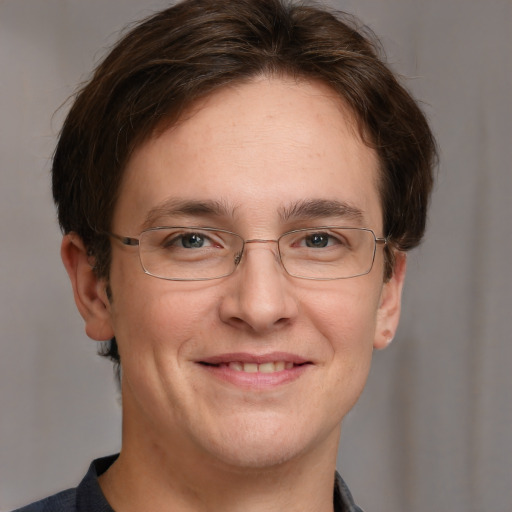 Joyful white adult male with short  brown hair and grey eyes