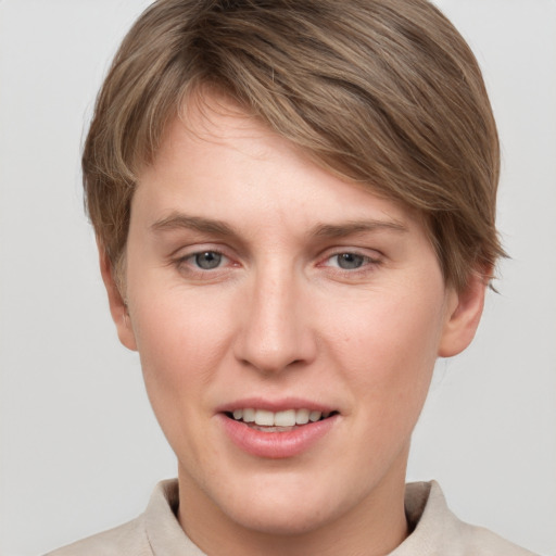 Joyful white young-adult female with short  brown hair and grey eyes