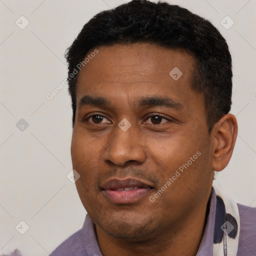 Joyful latino young-adult male with short  black hair and brown eyes