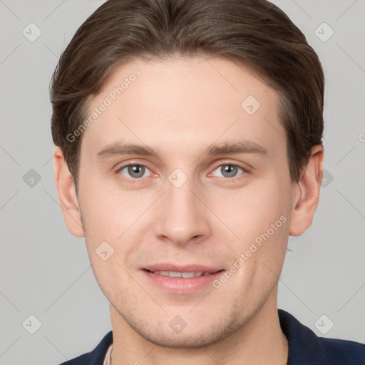 Joyful white young-adult male with short  brown hair and grey eyes