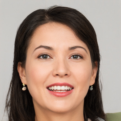 Joyful white young-adult female with long  brown hair and brown eyes