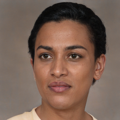 Joyful latino young-adult female with short  black hair and brown eyes