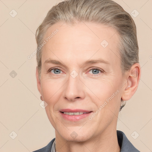 Joyful white adult female with short  brown hair and blue eyes