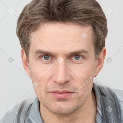 Joyful white adult male with short  brown hair and grey eyes