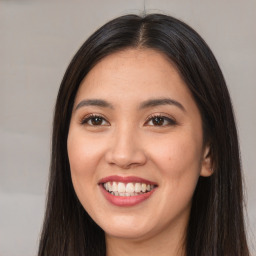 Joyful white young-adult female with long  brown hair and brown eyes