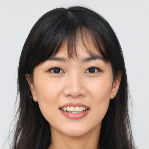 Joyful asian young-adult female with long  brown hair and brown eyes
