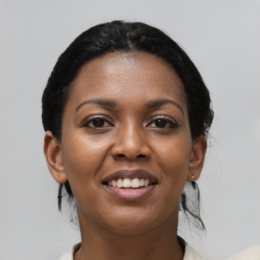 Joyful black young-adult female with medium  black hair and brown eyes