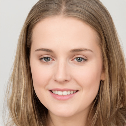 Joyful white young-adult female with long  brown hair and grey eyes