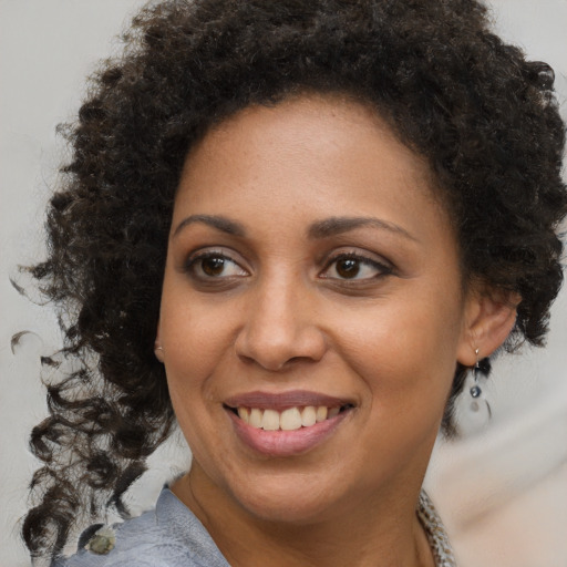 Joyful black young-adult female with medium  brown hair and brown eyes