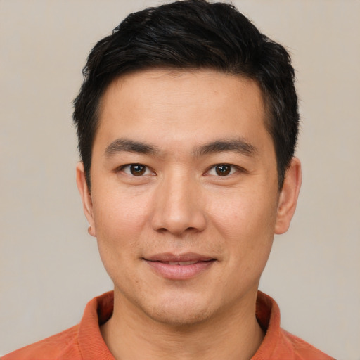 Joyful white young-adult male with short  black hair and brown eyes